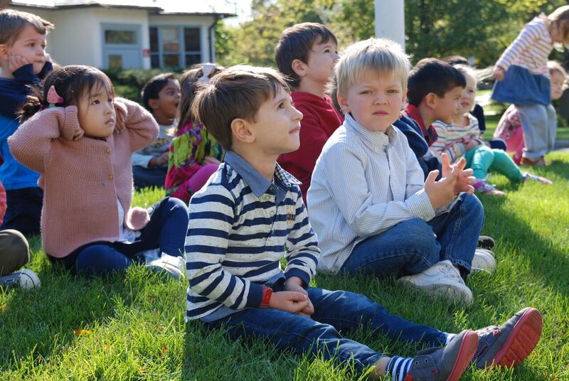 Glenview New Church School 1st and 2nd Grade students sit on the lawn for an outdoor lesson 
