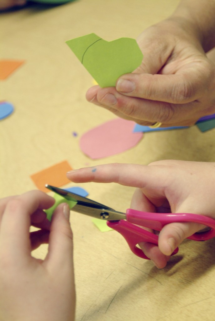 Glenview New Church school Students cut out shapes for an art project